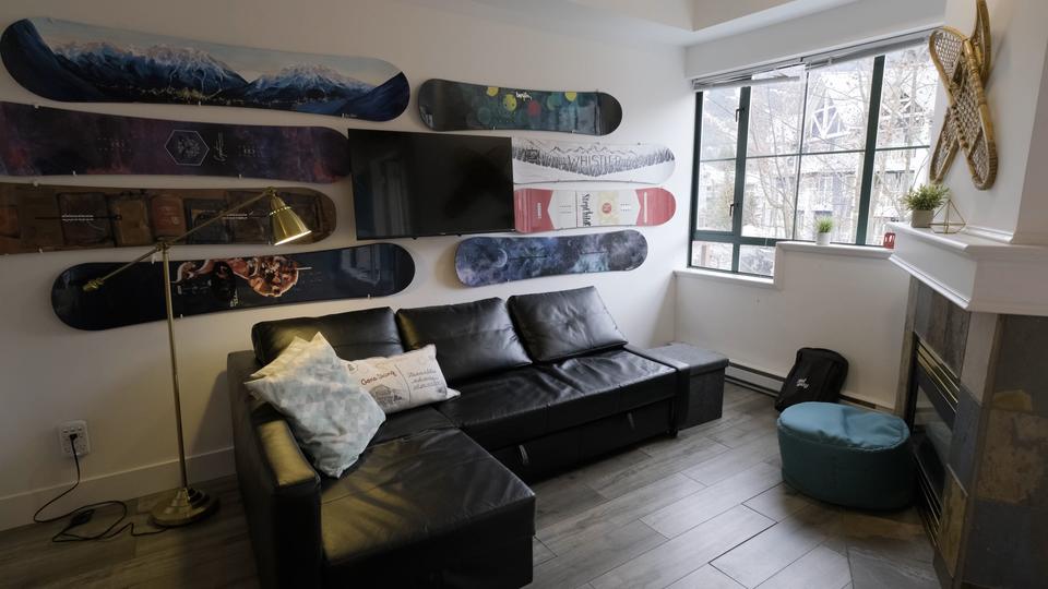 Lifty Life is a vacation rental property management company that has been a Hostaway customer since 2020. In that time, their company has grown by 600%. This is a picture of their flagship studio apartment in Whistler British Columbia featuring eight snowboard decks. 
